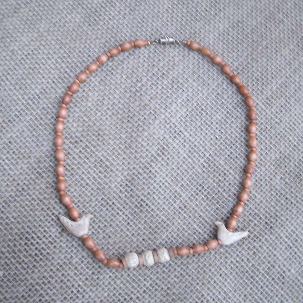 Vintage handmade necklace from 1980s. Made of various wood beads and metal seed
